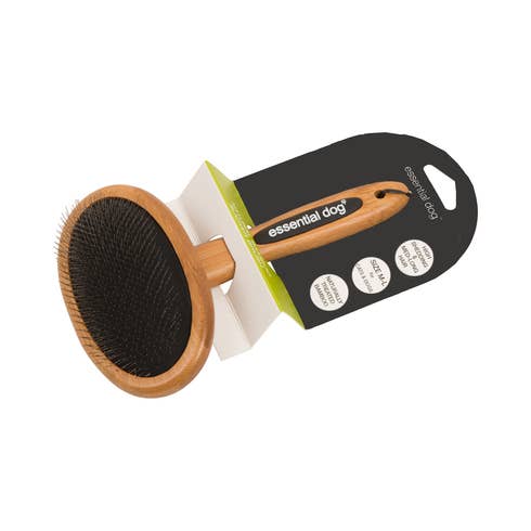 Bamboo dog grooming brush displayed with product packaging for natural dog grooming tools