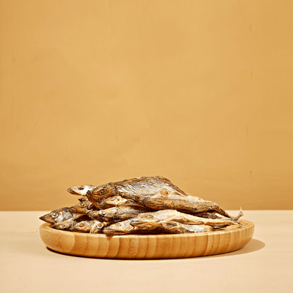 Freeze-dried capelin fish dog treats displayed on flat surface