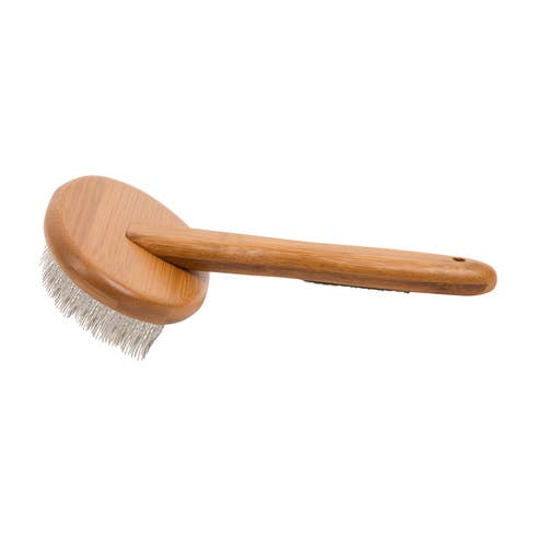 Side view of bamboo dog grooming brush showing handle and bristle surface