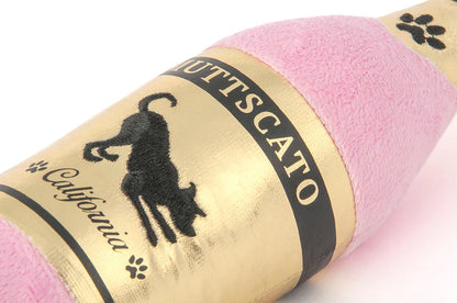 Close-up of champagne bottle dog toy showing soft plush material and design detail