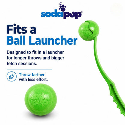 SodaPup Green Glitter dog ball shown with a ball launcher to demonstrate launcher compatibility
