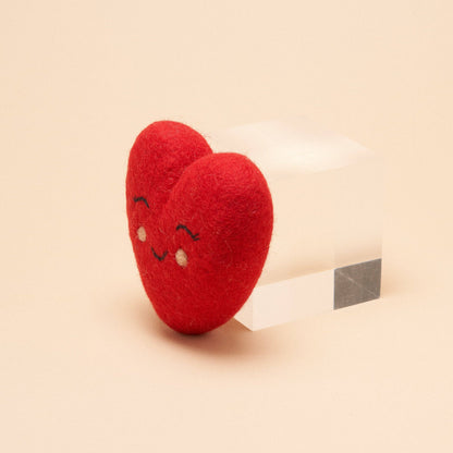 Natural wool heart dog toy for dogs, crafted from compostable wool with pet-safe, non-toxic dyes. Free from plastic and synthetic fillers.