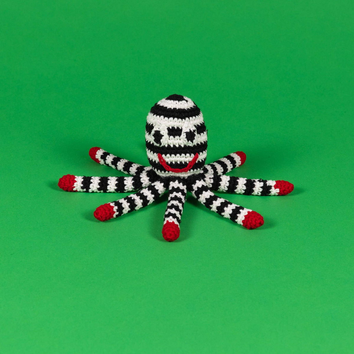 Black and white organic cotton octopus dog toy with red details and built-in squeaker