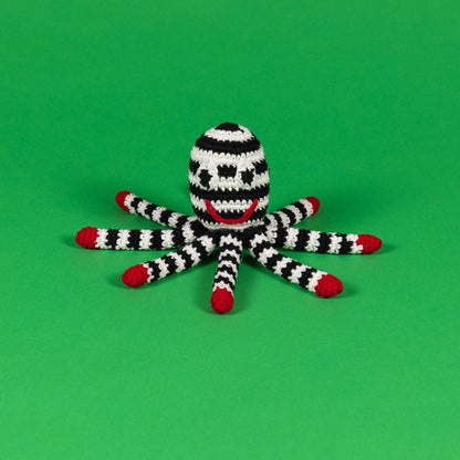 Black and white organic cotton octopus dog toy with red details and built-in squeaker