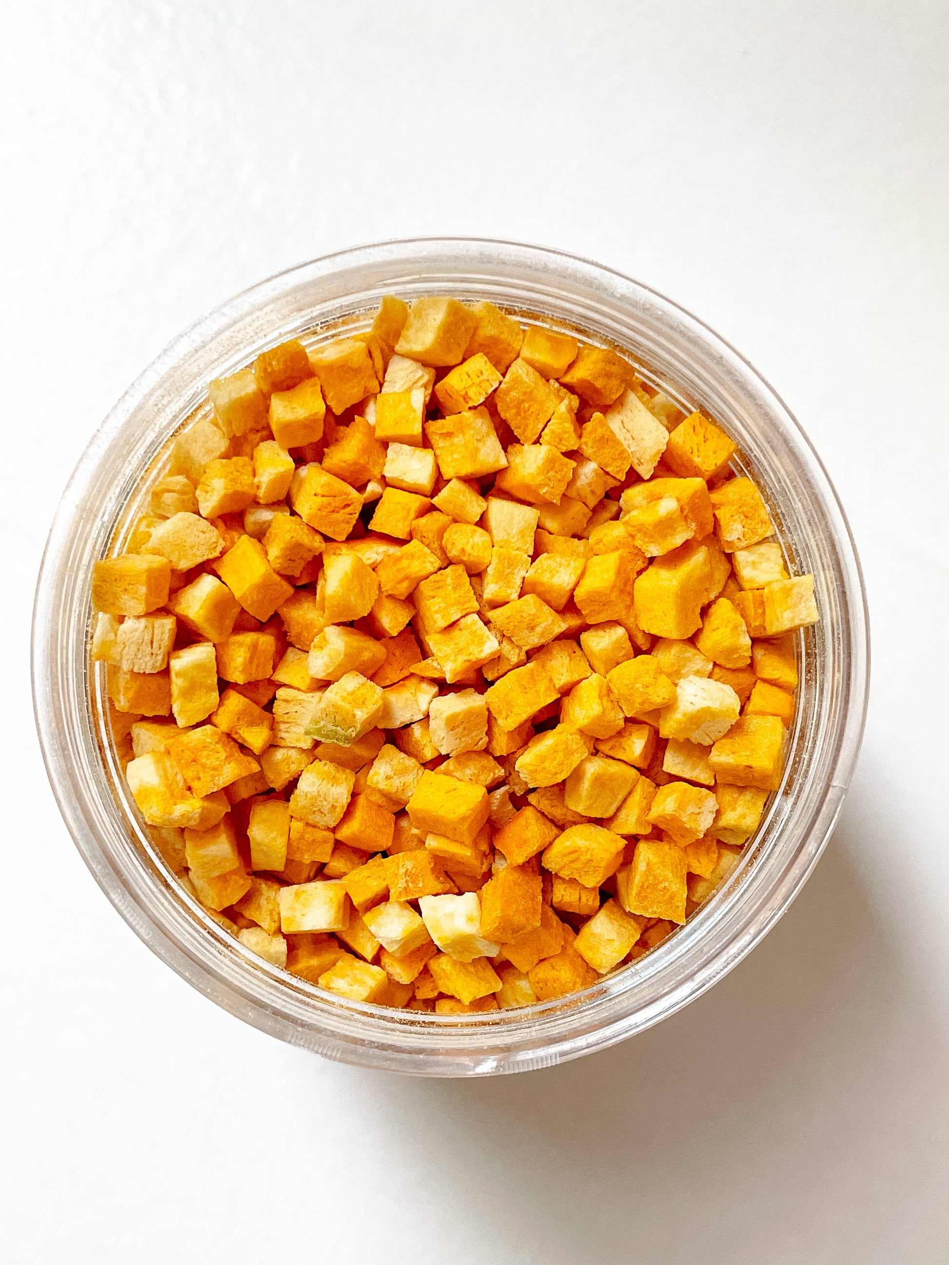 Close-up of freeze-dried pumpkin dog treats showing natural texture and color