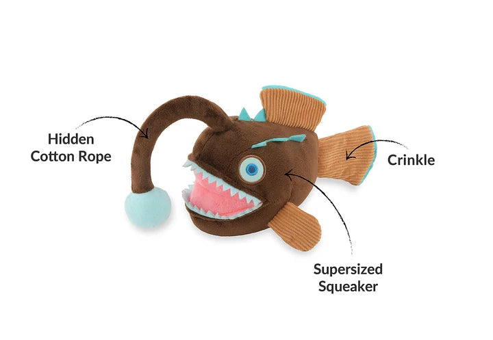 Diagram of angler fish dog toy highlighting its hidden rope, crinkles, and supersized squeaker