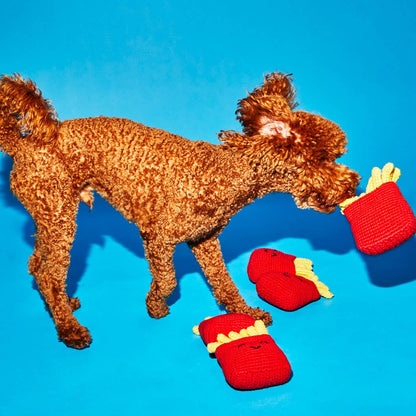 Dog playing with a lambswool french fries dog toy made from natural fibers with non-toxic dyes
