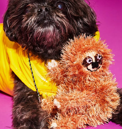 Dog playing with an organic cotton sloth dog toy made with non-toxic dyes, fair trade handmade for sustainable play