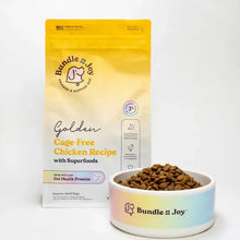 Bundle x Joy Golden Cage-Free Chicken Recipe dog food bag with kibble bowl on white background