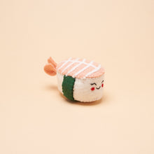 A handmade, shrimp nigiri-shaped dog toy made from 100% natural wool. 
