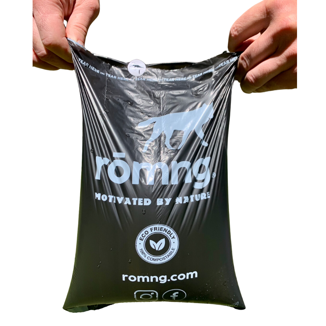 rōmng compostable dog poop bag held open to show strength, thickness, and size.
