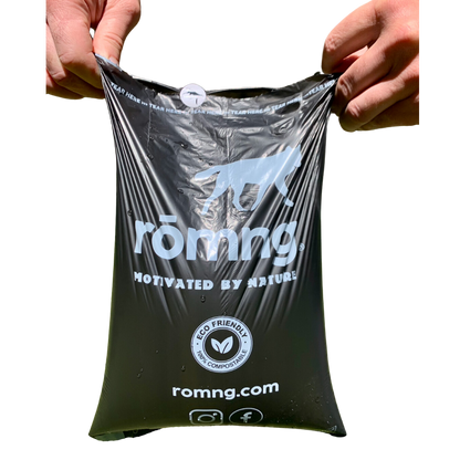 rōmng compostable dog poop bag held open to show strength, thickness, and size.
