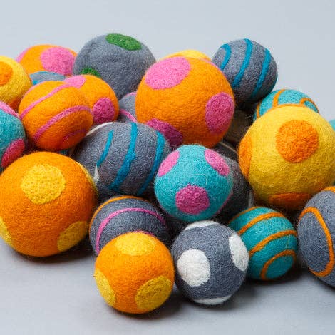Assorted wool ball dog toys handmade from 100% natural wool, fair trade crafted for fetch and interactive play.